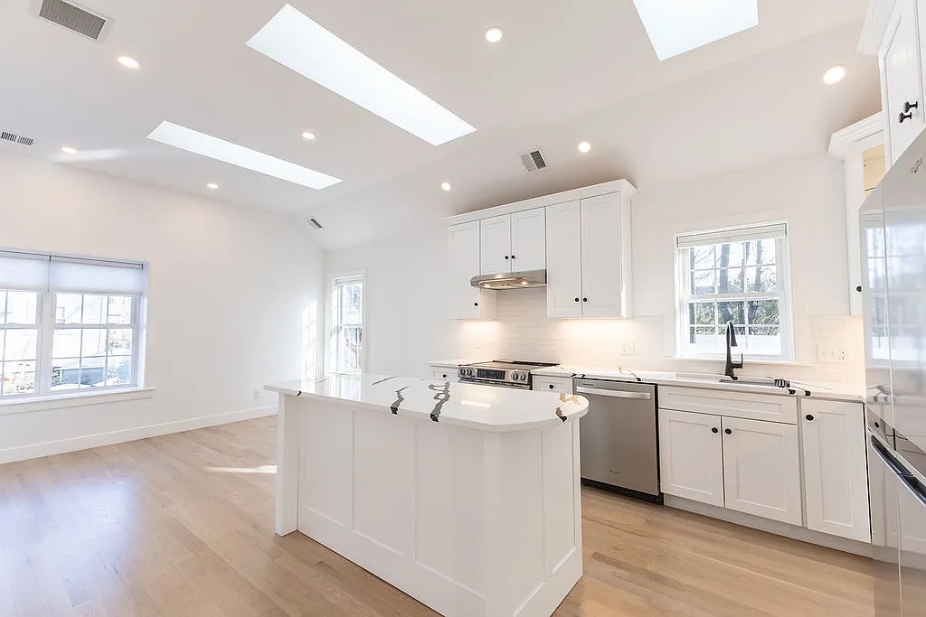 Open kitchen and living area of the Norwood ADU, with a vaulted ceiling and three skylights